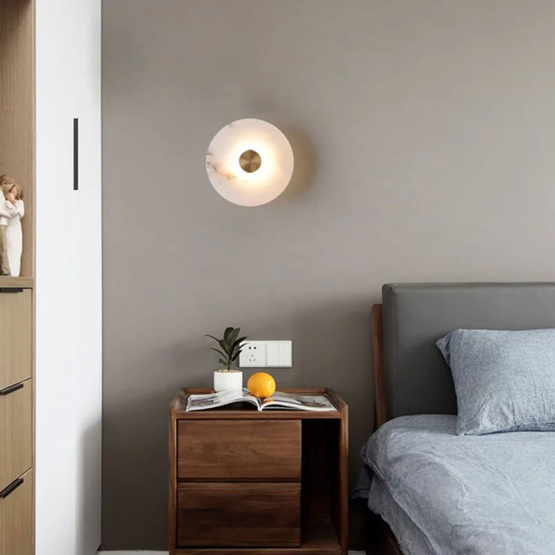 Modern bedroom with wooden nightstand, open book, and decorative items.